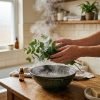 Hands_holding_eucalyptus_over_water_202609080047