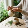 Hands_pouring_herbal_infusion_202609072159
